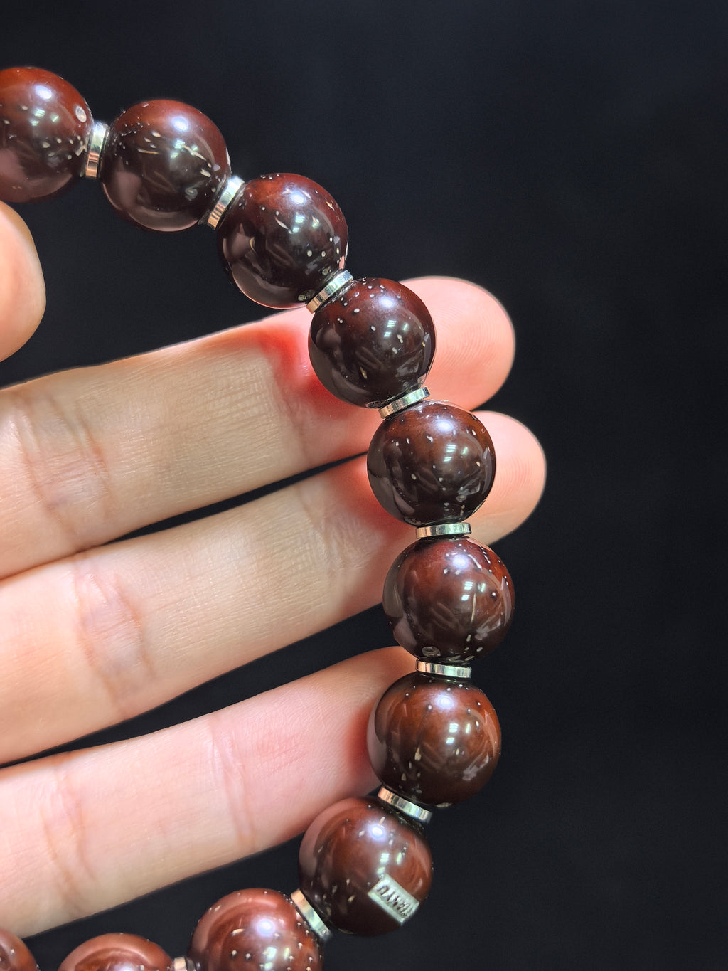Fortune Seed (Zi Jin Shu) barrel bracelet by ZenWenwan with 12mm beads and sterling silver spacers on a person's wrist.